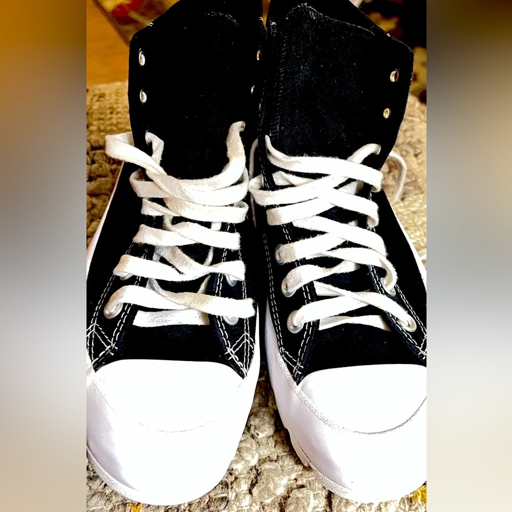 Women’s size 9 Converse All Star. Black Chuck Taylors. With a 1.5 “ lift